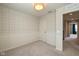 A cozy bedroom with stylish wallpaper, white trim, neutral carpet and a decorative ceiling light at 1208 Chapman Dr, Westfield, IN 46074