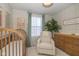 Cozy Bedroom featuring a wooden crib, comfortable chair, and stylish decor, creating a warm and inviting space at 1208 Chapman Dr, Westfield, IN 46074
