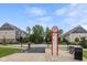 Scenic neighborhood view featuring condo-style homes, grassy areas, a cyclist, and a directory at 1208 Chapman Dr, Westfield, IN 46074