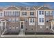 Inviting brick and siding townhome with meticulously maintained landscaping and a welcoming front entrance at 1208 Chapman Dr, Westfield, IN 46074