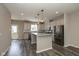 A modern kitchen featuring stainless steel appliances, granite countertops, an island and hardwood floors at 1208 Chapman Dr, Westfield, IN 46074