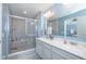 Beautiful bathroom with a double vanity, a large mirror, and a tiled walk-in shower with a bench at 1208 Chapman Dr, Westfield, IN 46074