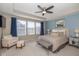 Bedroom with a tray ceiling, large windows, a sitting area, and ample natural light at 1208 Chapman Dr, Westfield, IN 46074