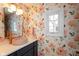 Charming bathroom with decorative floral wallpaper, white vanity countertop and pink vessel sink at 12107 Castle Row Overlook, Carmel, IN 46033