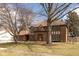 Beautiful brick home featuring a well-manicured lawn and mature trees in the front yard at 12107 Castle Row Overlook, Carmel, IN 46033