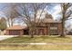 Charming brick home featuring a well-manicured lawn and a large mature tree in the front yard at 12107 Castle Row Overlook, Carmel, IN 46033
