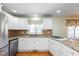 Kitchen featuring white cabinets, granite countertops, stainless steel appliances, and hardwood flooring at 12107 Castle Row Overlook, Carmel, IN 46033