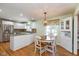 Eat-in kitchen with white cabinets, granite countertops, stainless steel appliances, and round table with seating at 12107 Castle Row Overlook, Carmel, IN 46033