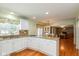 Kitchen features white cabinets, granite countertops, stainless steel appliances, and access to the dining room at 12107 Castle Row Overlook, Carmel, IN 46033