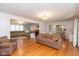 Open-concept living room featuring hardwood flooring, a neutral color palette, and ample natural light at 12107 Castle Row Overlook, Carmel, IN 46033