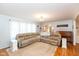 Bright living room with a large sectional sofa and a piano, creating an inviting atmosphere at 12107 Castle Row Overlook, Carmel, IN 46033