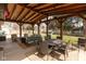 Covered patio with outdoor seating, dining area, and view of the lush backyard, perfect for entertaining at 12107 Castle Row Overlook, Carmel, IN 46033