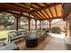 Relaxing covered patio features comfortable seating around a fire pit, ideal for outdoor gatherings at 12107 Castle Row Overlook, Carmel, IN 46033