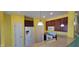Bright kitchen features white appliances, a large island, and dark wood cabinets at 1223 Blackthorne S Trl, Plainfield, IN 46168