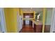 Bright eat-in kitchen with wooden floors, granite countertops, stainless steel appliances and yellow walls at 1223 Blackthorne S Trl, Plainfield, IN 46168