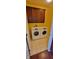 Laundry room features full-size washer and dryer with overhead storage cabinets at 1223 Blackthorne S Trl, Plainfield, IN 46168