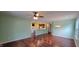 Living room featuring hardwood floors, view to the kitchen and staircase to the upper level at 1223 Blackthorne S Trl, Plainfield, IN 46168