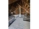Attic featuring exposed rafters, a brick chimney, and wooden beams at 123 S Butler Ave, Indianapolis, IN 46219