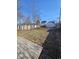 Large backyard featuring detached garage, wood fence, and sunny lawn at 123 S Butler Ave, Indianapolis, IN 46219