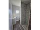 Remodeled bathroom featuring modern fixtures, new shower tiles, and updated vanity at 123 S Butler Ave, Indianapolis, IN 46219