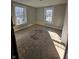 Bedroom renovation in progress with plywood subfloor and two windows at 123 S Butler Ave, Indianapolis, IN 46219