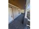 Covered porch featuring gray concrete flooring, white support columns, and access to the home's entrance at 123 S Butler Ave, Indianapolis, IN 46219