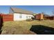 Spacious backyard featuring a well-maintained lawn, privacy fence, and outdoor seating area at 12329 Wolf Run Rd, Noblesville, IN 46060