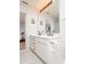 Bright bathroom featuring double sinks, white cabinets, and modern fixtures at 12329 Wolf Run Rd, Noblesville, IN 46060