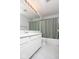 Bathroom with white vanity, large mirror, and shower with sage green curtain at 12329 Wolf Run Rd, Noblesville, IN 46060