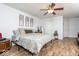 Bright bedroom features hardwood floors, neutral walls, and a ceiling fan at 12329 Wolf Run Rd, Noblesville, IN 46060