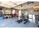 Spacious home garage featuring an exercise area, storage shelves and more at 12329 Wolf Run Rd, Noblesville, IN 46060