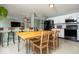 Spacious eat-in kitchen with a dining table, barstool seating, and stainless steel appliances at 12329 Wolf Run Rd, Noblesville, IN 46060
