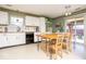 Bright kitchen with white cabinets, modern appliances, and a dining area at 12329 Wolf Run Rd, Noblesville, IN 46060