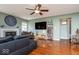 Comfortable living room with fireplace, ceiling fan, and hardwood floors at 12329 Wolf Run Rd, Noblesville, IN 46060