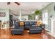 Open-concept living room with a view into the kitchen and hardwood floors at 12329 Wolf Run Rd, Noblesville, IN 46060