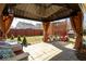 Inviting covered patio with comfortable seating and outdoor grill, perfect for relaxing or entertaining guests at 12329 Wolf Run Rd, Noblesville, IN 46060