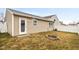 View of the backyard showcasing the fire pit, yard, and door to the house at 13332 N Brick Chapel Dr, Camby, IN 46113