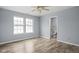 Bedroom with natural light, wood floors, and an en-suite bathroom at 13332 N Brick Chapel Dr, Camby, IN 46113