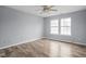 Spacious bedroom with wood-look floors and a window offering natural light at 13332 N Brick Chapel Dr, Camby, IN 46113