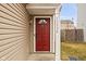 Close-up of a red front door with decorative glass and visible house number at 13332 N Brick Chapel Dr, Camby, IN 46113
