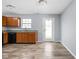 Cozy kitchen area featuring wood cabinets, laminate counters, and modern flooring at 13332 N Brick Chapel Dr, Camby, IN 46113