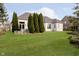 Spacious backyard with lush green grass, patio, and privacy trees at 14020 Quarter Horse Ct, Carmel, IN 46032