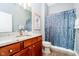 Bathroom with tile flooring, granite countertop vanity, decorative mirror, and shower with decorative curtain at 14020 Quarter Horse Ct, Carmel, IN 46032