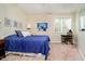 Comfortable bedroom with blue bedding, natural light, and a small desk area at 14020 Quarter Horse Ct, Carmel, IN 46032