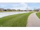 Community walking path along green space and frozen pond at 14020 Quarter Horse Ct, Carmel, IN 46032