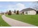 Lush backyard and brick home with beautiful landscaping, and a walking path at 14020 Quarter Horse Ct, Carmel, IN 46032