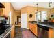 Well-lit kitchen featuring granite countertops, stainless steel appliances, and access to adjacent dining area at 14020 Quarter Horse Ct, Carmel, IN 46032