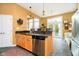 Bright kitchen island with stainless steel appliances and a view into the sun room at 14020 Quarter Horse Ct, Carmel, IN 46032