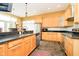 Bright kitchen featuring stainless steel appliances, stone tile floor, granite countertops, and breakfast bar at 14020 Quarter Horse Ct, Carmel, IN 46032