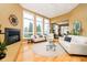 Bright living room featuring three large sunny windows and a cozy fireplace at 14020 Quarter Horse Ct, Carmel, IN 46032